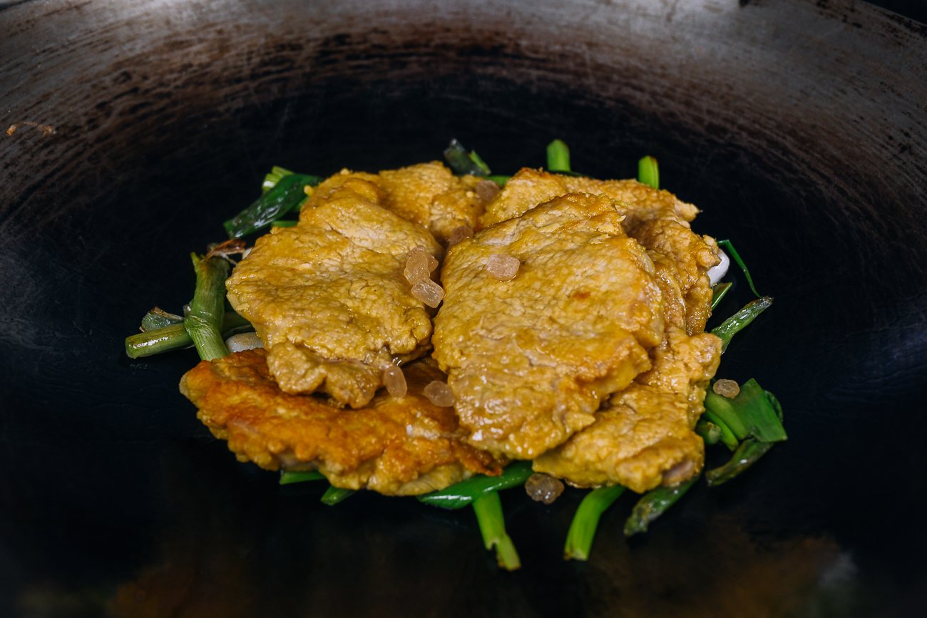 pork chops on bed of scallions