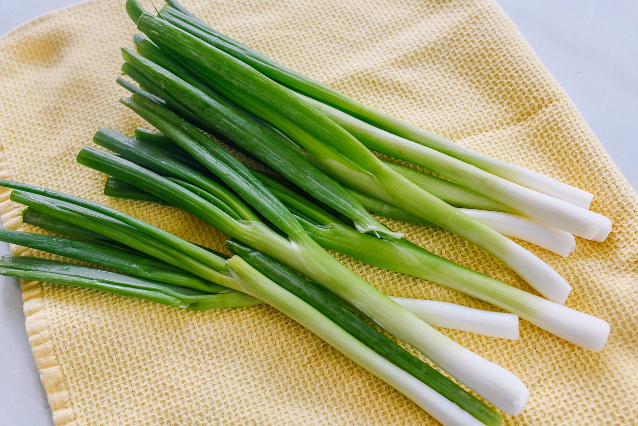 washed scallions on kitchen towel